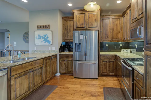 a kitchen with cabinets and stainless steel appliances