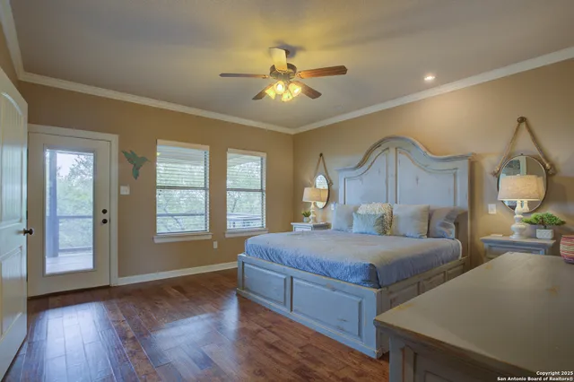 a bedroom with a large bed and a chandelier
