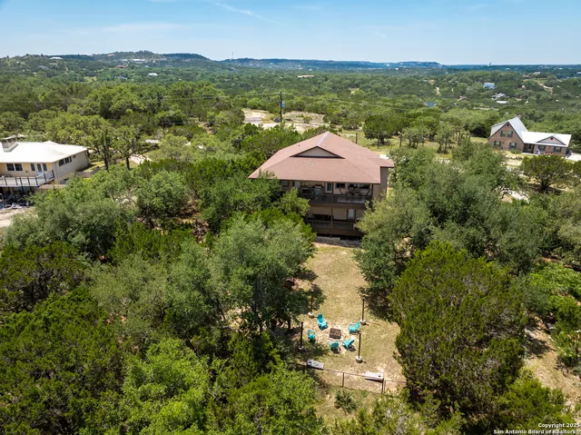 a view of house with backyard and outdoor seating
