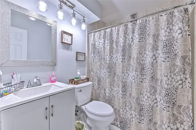 a bedroom with two beds and a chandelier