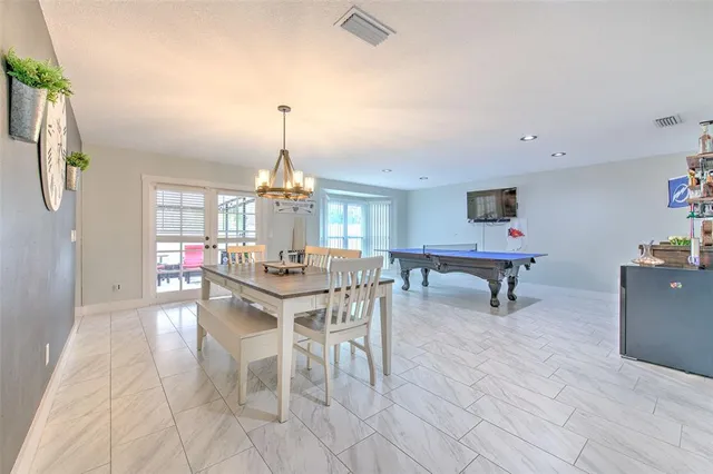 a room with pool table and lots of wooden furniture