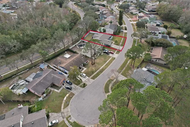 an aerial view of residential houses with outdoor space and swimming pool