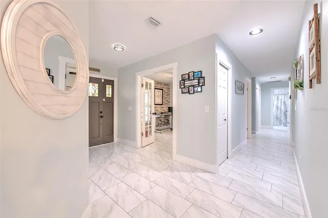 a bedroom with a large bed and a ceiling fan
