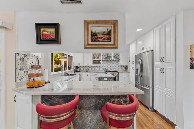 a bedroom with a bed dresser and wooden floor