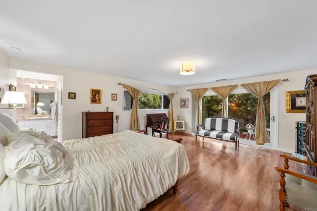 a spacious bathroom with a tub sink and mirror