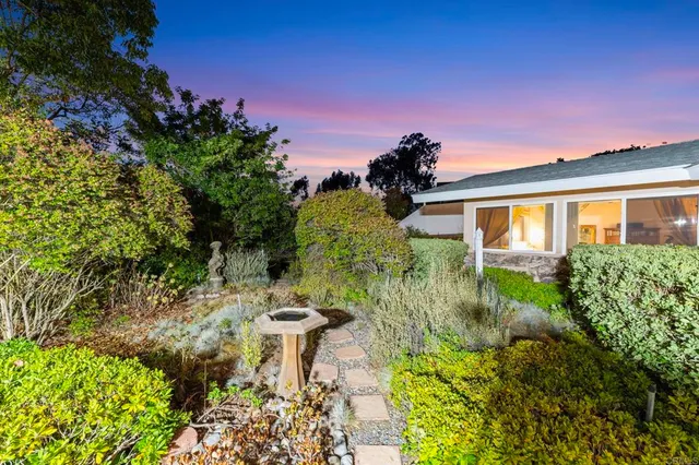 a view of a patio with table and chairs and potted plants