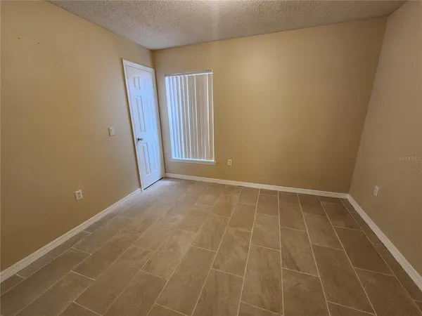 a view of an empty room with windows