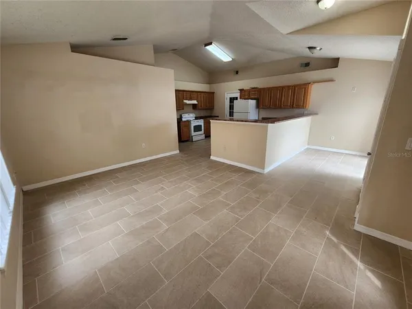a view of kitchen with refrigerator and window