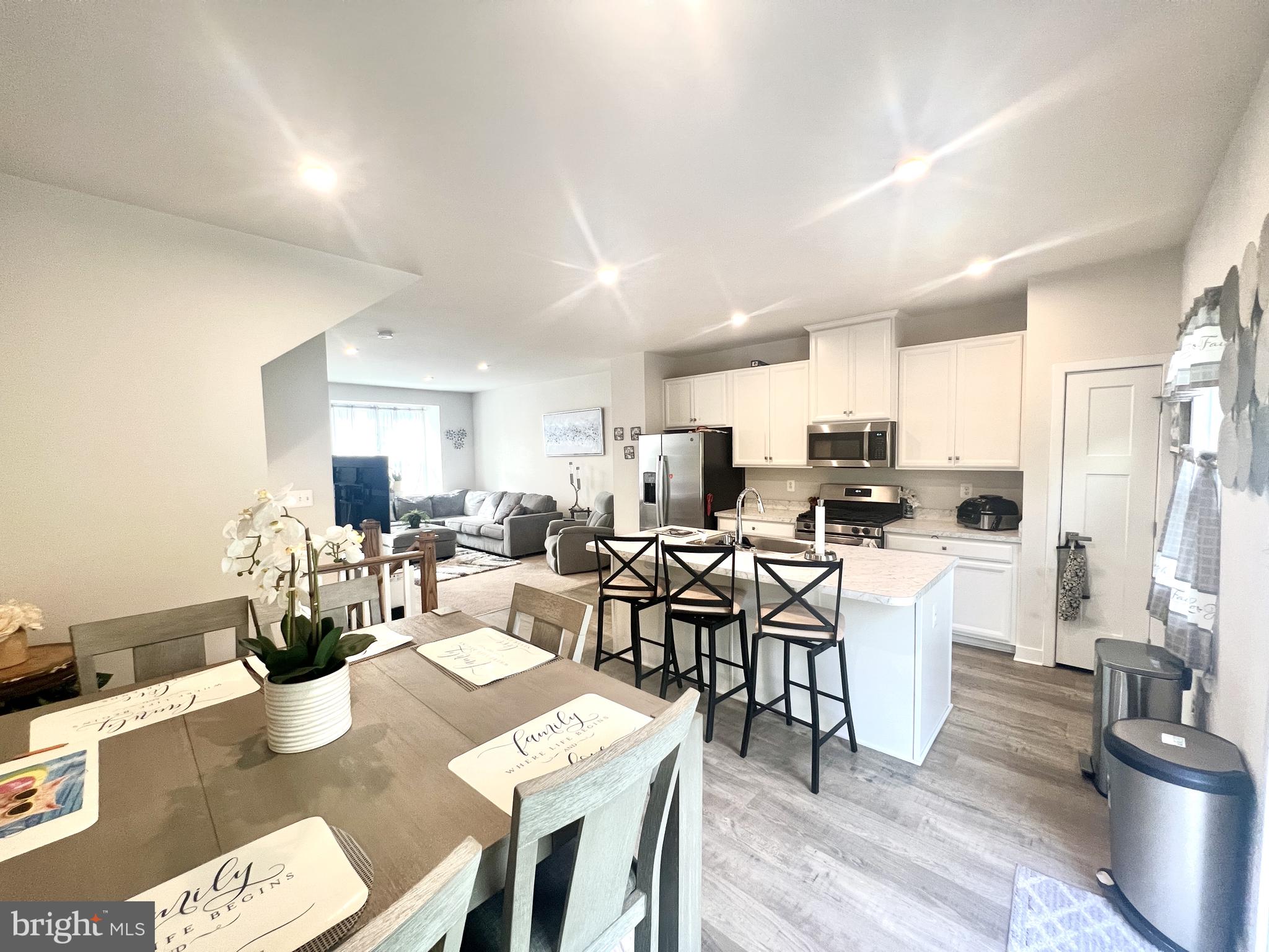 2060 Rivers Drive Newark, DE 19702 - Photo 11 of 25 a view of a dining room with furniture a rug and wooden floor