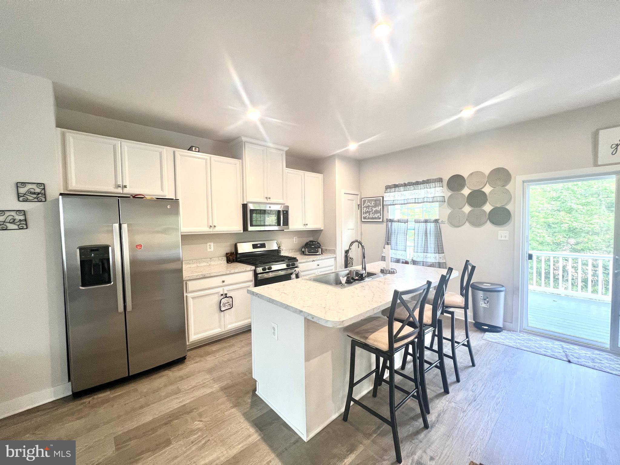 2060 Rivers Drive Newark, DE 19702 - Photo 9 of 25 a kitchen with stainless steel appliances a dining table chairs refrigerator and cabinets