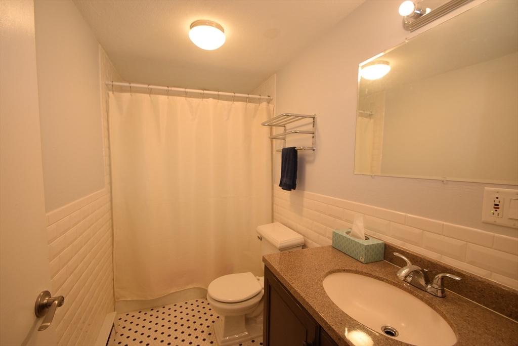 13 Walker Road, Unit 12 North Andover, MA 01845 - Photo 12 of 18 a bathroom with a sink toilet a mirror and shower
