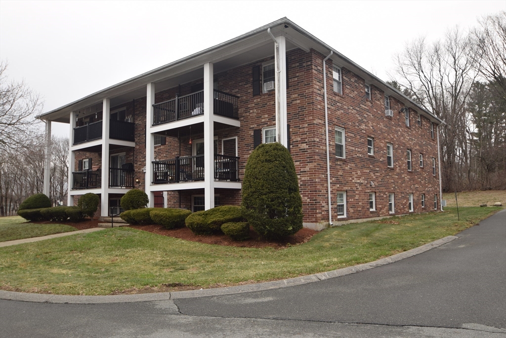 13 Walker Road, Unit 12 North Andover, MA 01845 - Photo 13 of 18 a view of a brick building next to a yard