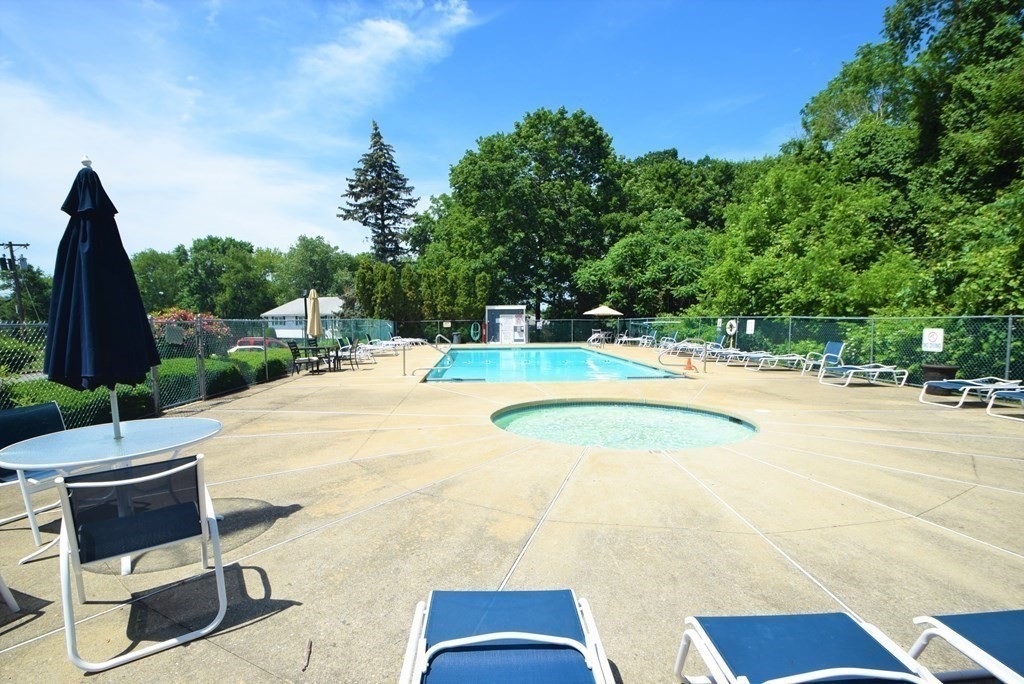 13 Walker Road, Unit 12 North Andover, MA 01845 - Photo 3 of 18 a swimming pool with some potted plants and large trees
