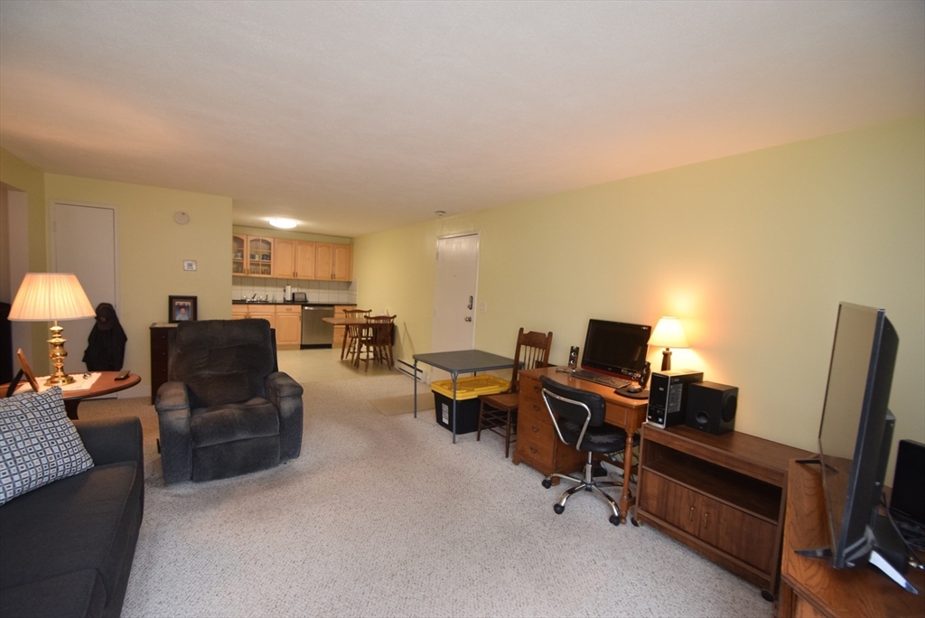 13 Walker Road, Unit 12 North Andover, MA 01845 - Photo 6 of 18 a living room with furniture and a flat screen tv