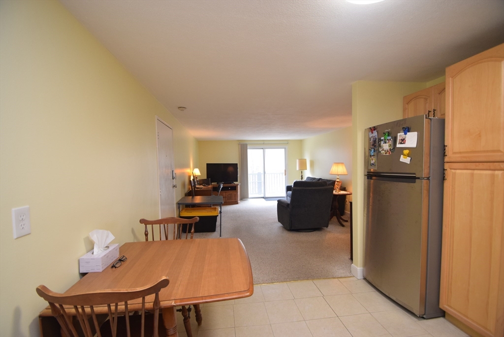 13 Walker Road, Unit 12 North Andover, MA 01845 - Photo 7 of 18 a living room with furniture and a refrigerator