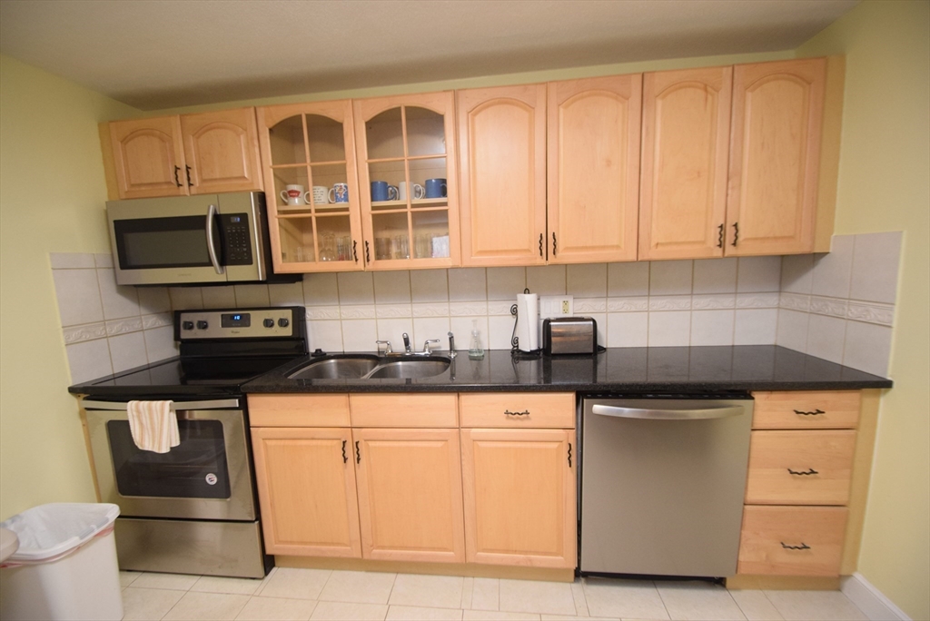 13 Walker Road, Unit 12 North Andover, MA 01845 - Photo 10 of 18 a kitchen with granite countertop white cabinets and stainless steel appliances