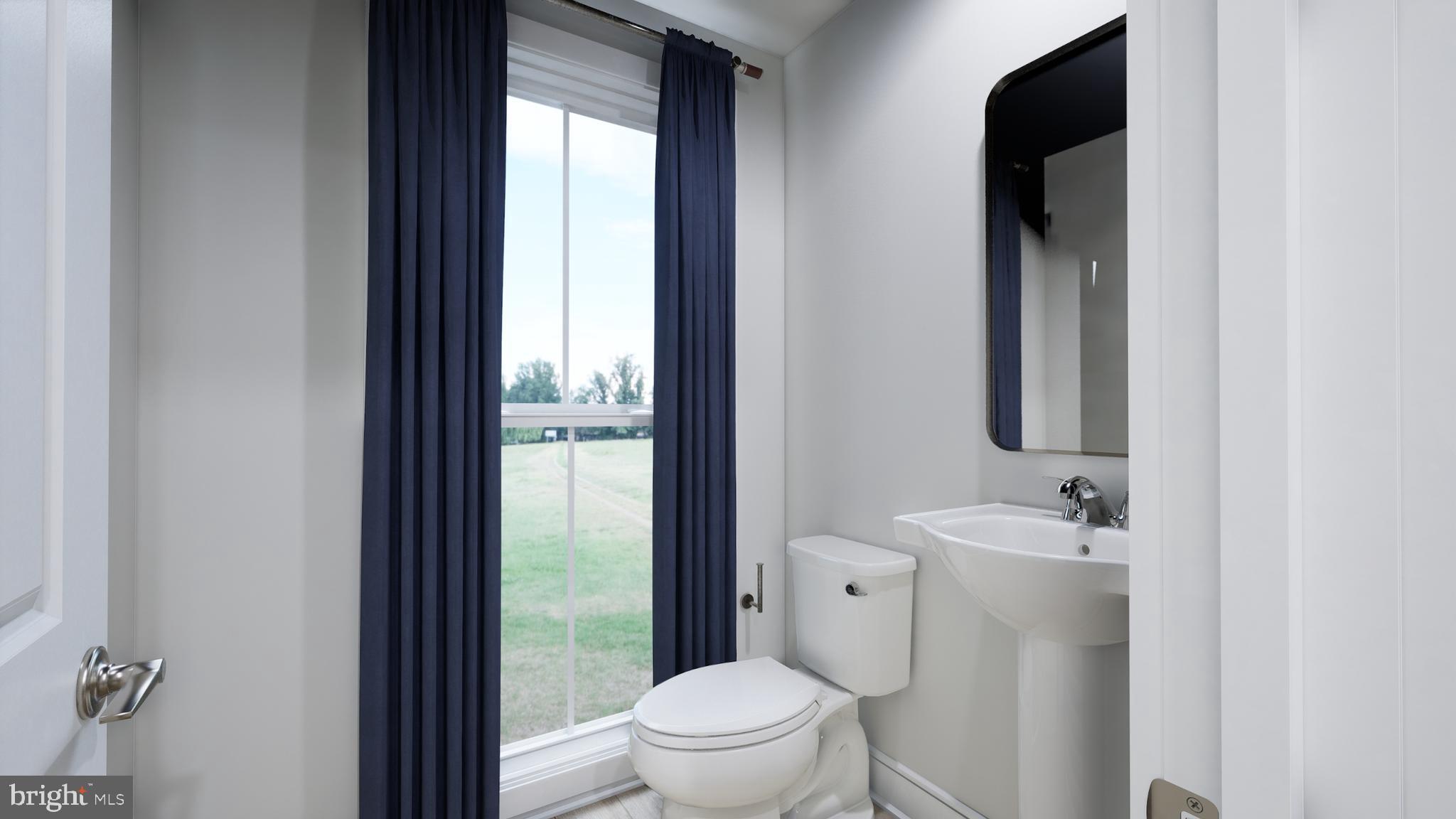 9739 Grant Avenue Manassas, VA 20110 - Photo 11 of 33 a bathroom with a sink a toilet and a mirror