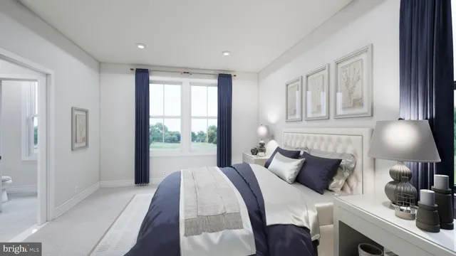 a bedroom with furniture and a large window