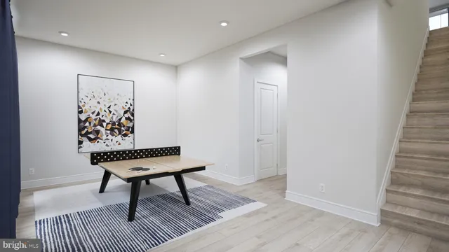 a view of a hallway with wooden floor and a bookshelf