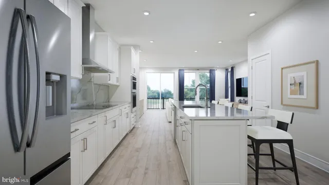a large white kitchen with a large window and stainless steel appliances