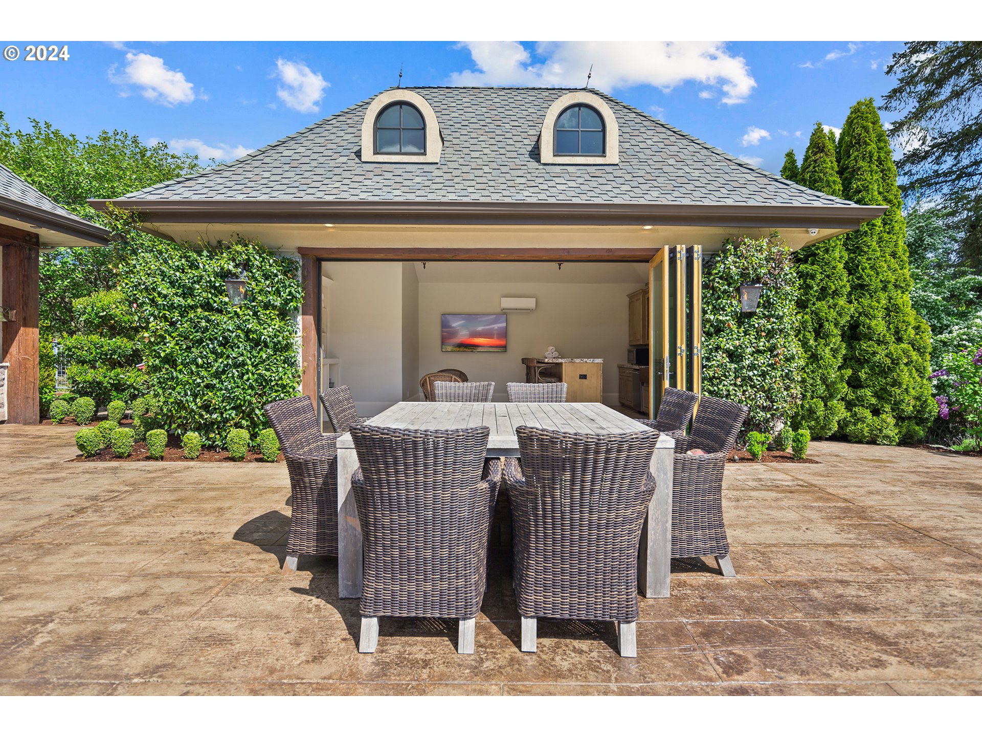 421 Northwest 209th Street Ridgefield, WA 98642 - Photo 21 of 48 a view of a patio with table and chairs under an umbrella