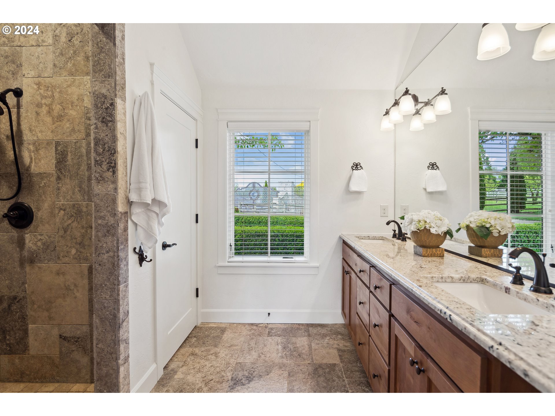 421 Northwest 209th Street Ridgefield, WA 98642 - Photo 45 of 48 a bathroom with a granite countertop sink a large mirror and a shower