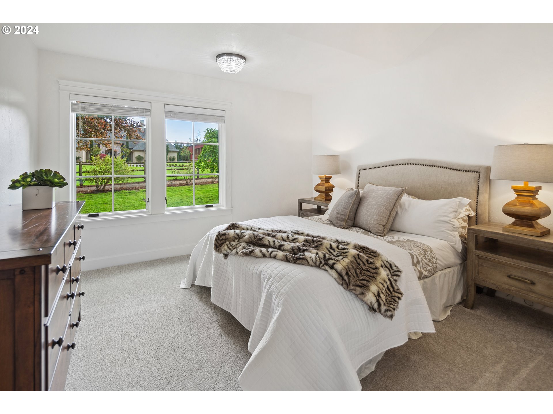 421 Northwest 209th Street Ridgefield, WA 98642 - Photo 46 of 48 a spacious bedroom with a bed and a large window