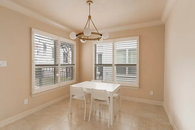 a dining room with a chandelier and windows