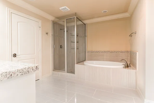 a spacious bathroom with a bathtub and shower