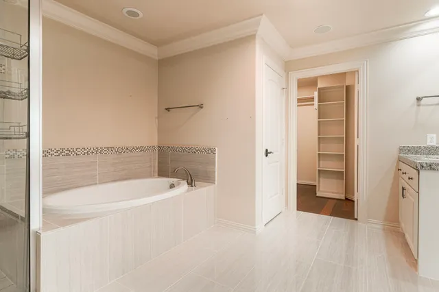 a bathroom with a bathtub and a shower