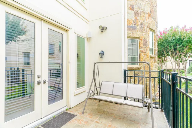 a view of porch with a bench and floor to ceiling window