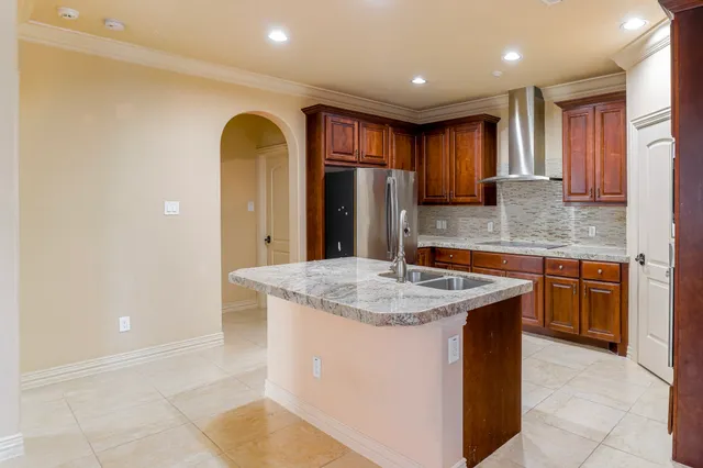 a kitchen with stainless steel appliances granite countertop a sink a counter space and cabinets