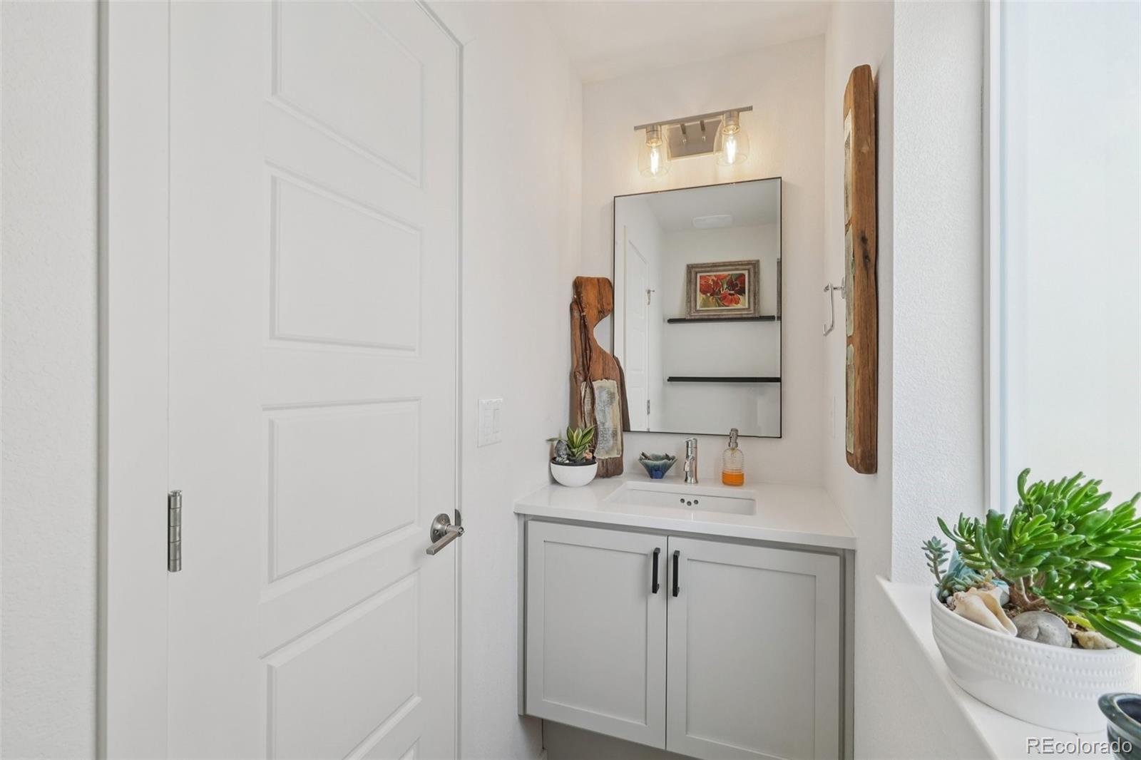 2005 West 66th Avenue Denver, CO 80221 - Photo 14 of 47 a bathroom with a sink and a mirror