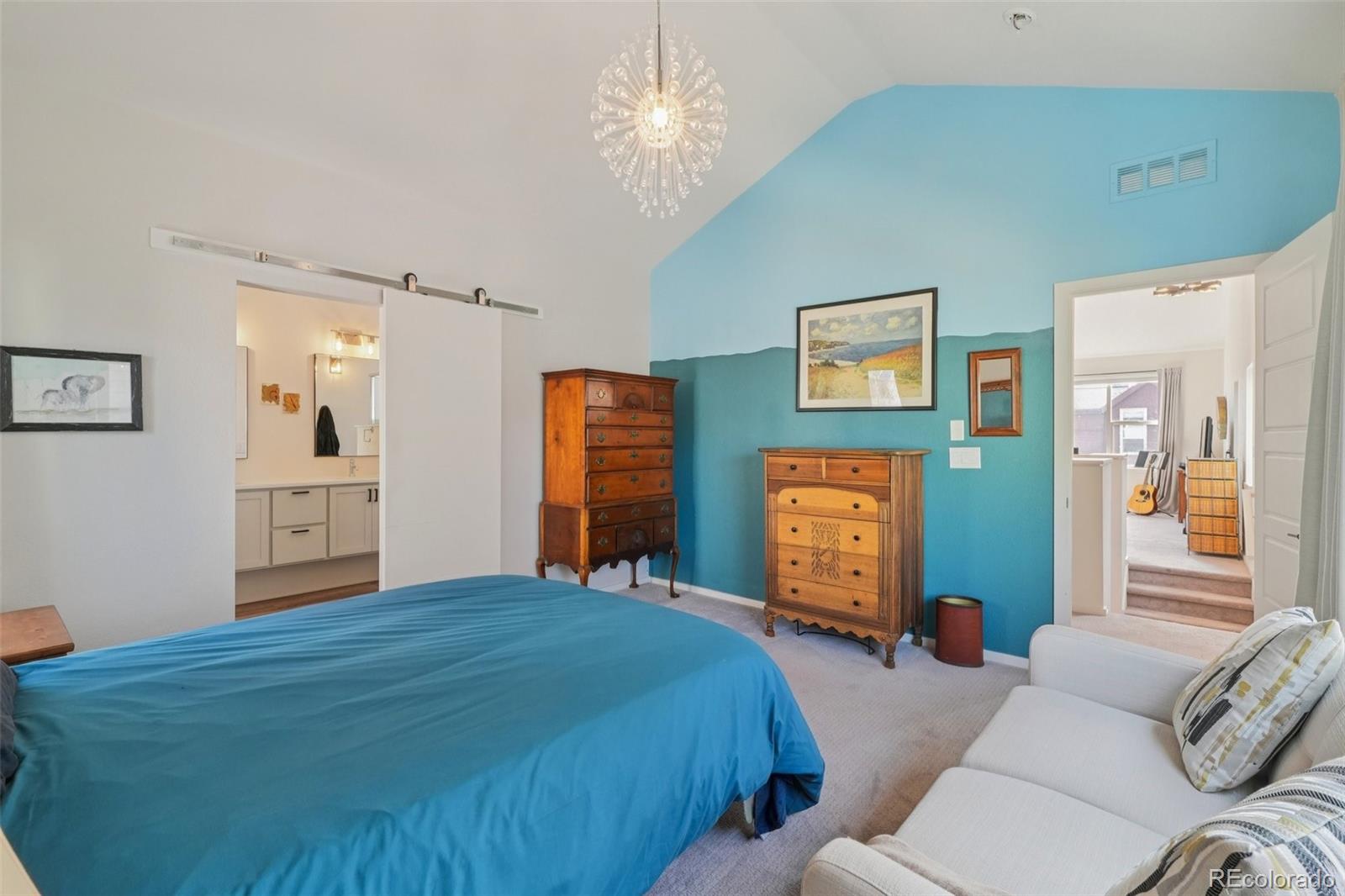 2005 West 66th Avenue Denver, CO 80221 - Photo 16 of 47 a bedroom with a bed and dresser with mirror