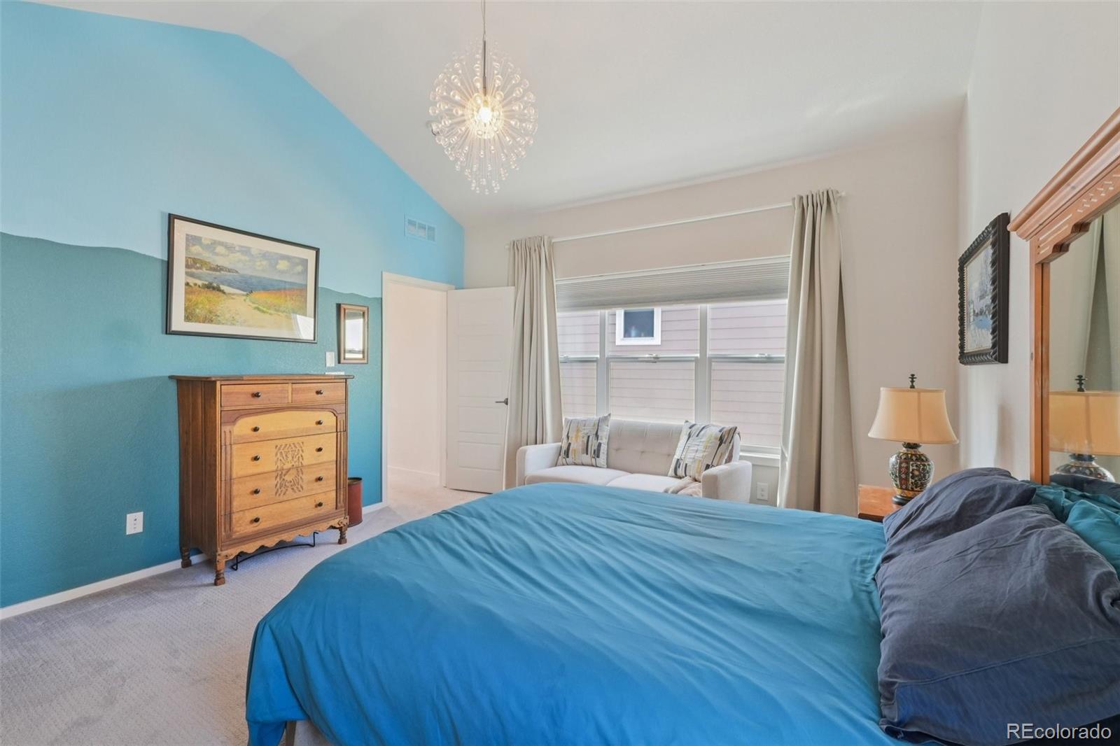 2005 West 66th Avenue Denver, CO 80221 - Photo 18 of 47 a bedroom with a bed and a chandelier