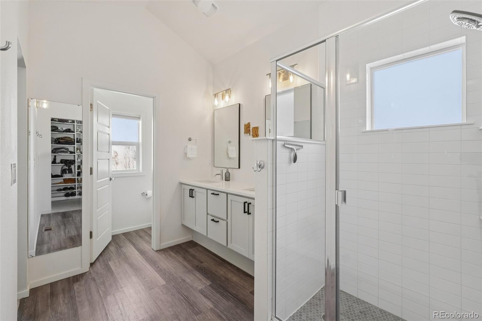 2005 West 66th Avenue Denver, CO 80221 - Photo 20 of 47 a bathroom with a double vanity sink and mirror