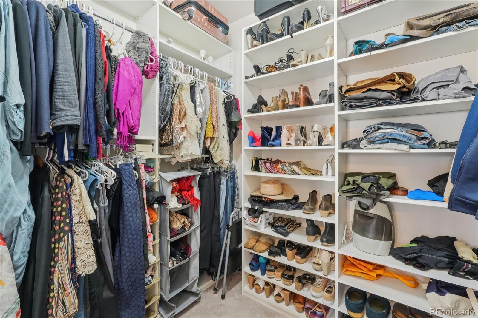 2005 West 66th Avenue Denver, CO 80221 - Photo 21 of 47 a view of walk in closet with clothes and shoes