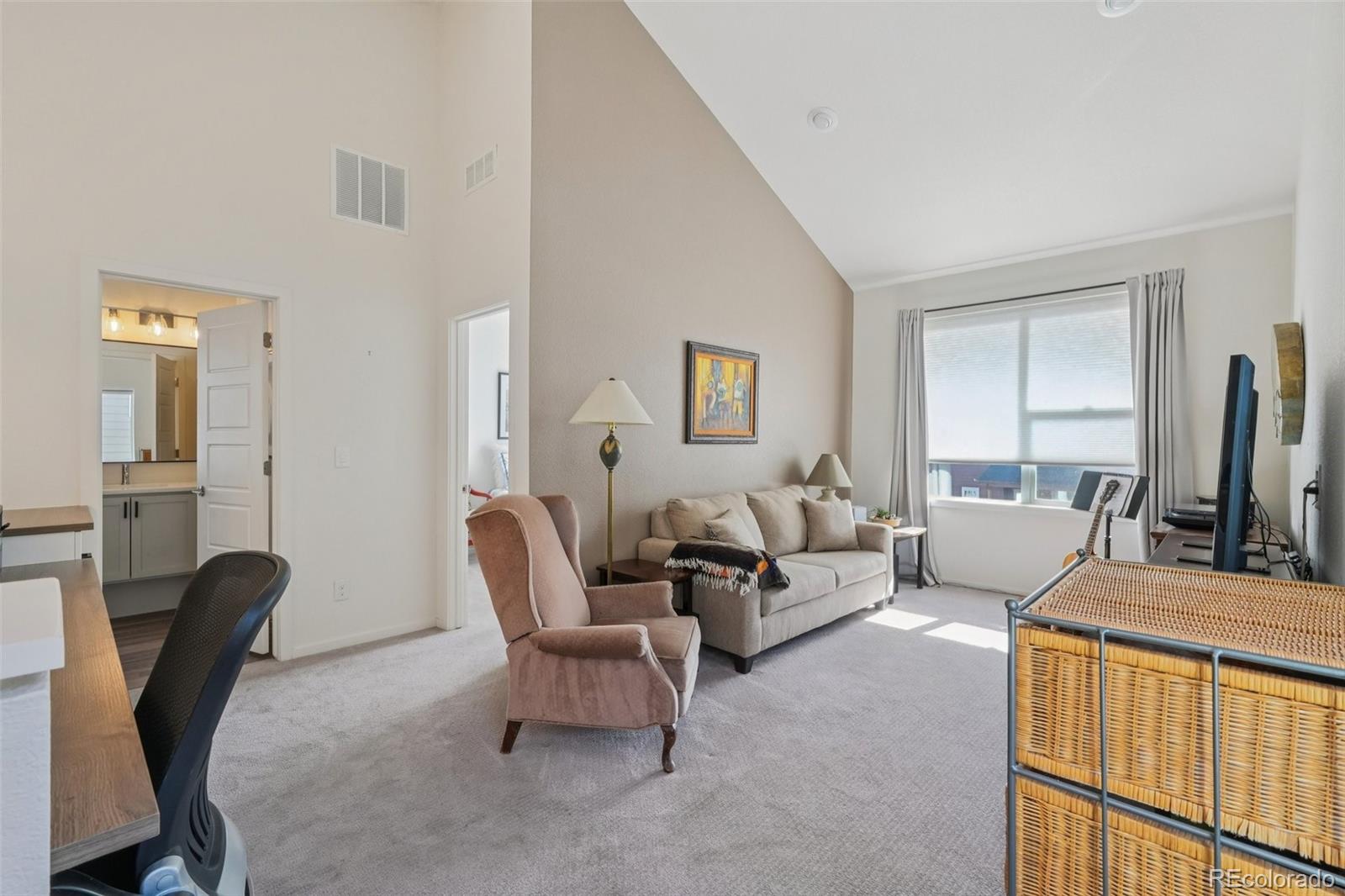 2005 West 66th Avenue Denver, CO 80221 - Photo 22 of 47 a living room with furniture a flat screen tv and a window