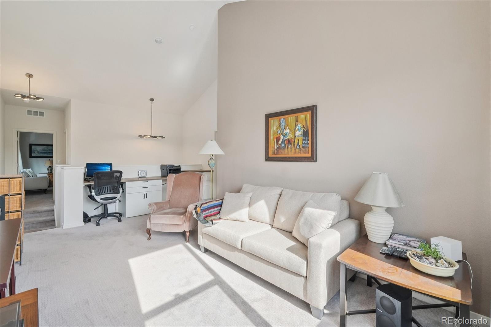 2005 West 66th Avenue Denver, CO 80221 - Photo 25 of 47 a living room with furniture and a dining table with chair