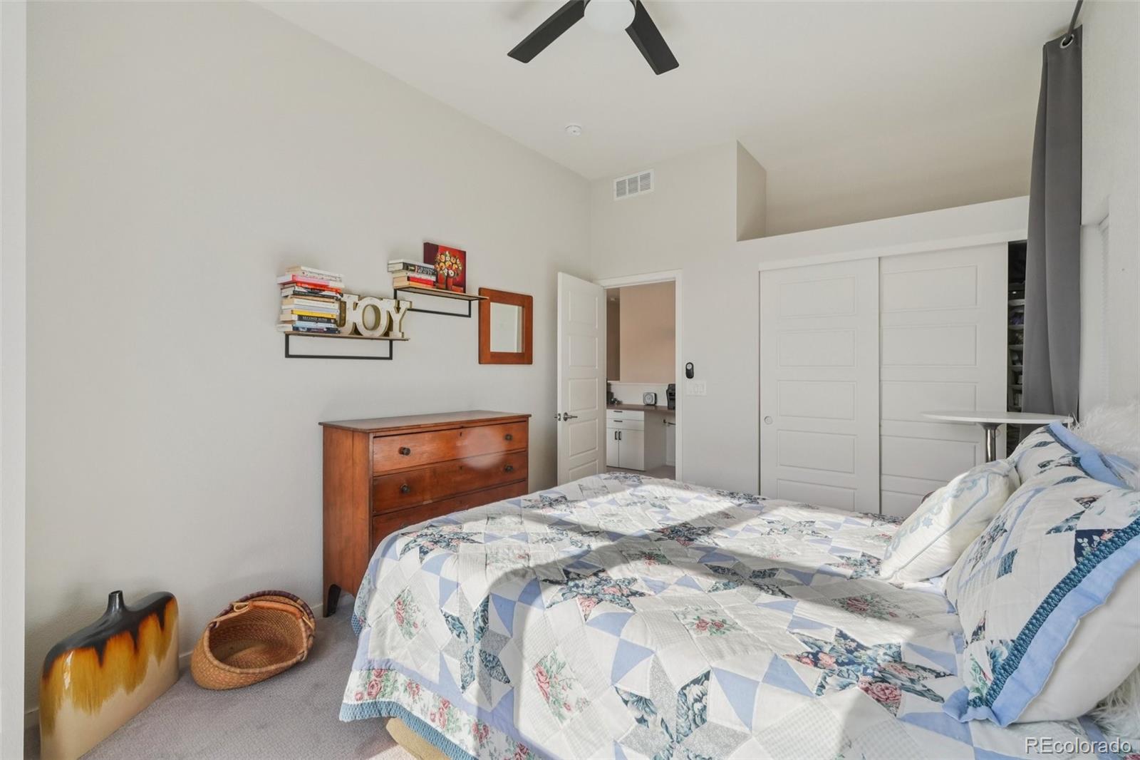 2005 West 66th Avenue Denver, CO 80221 - Photo 32 of 47 a bedroom with a bed and a chandelier