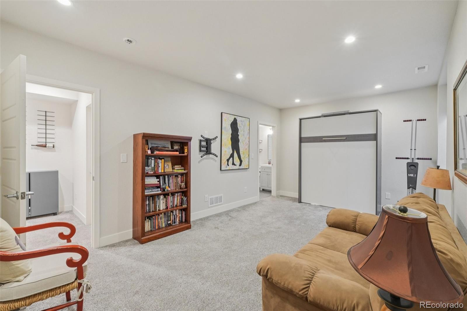 2005 West 66th Avenue Denver, CO 80221 - Photo 36 of 47 a bedroom with furniture and a book shelf