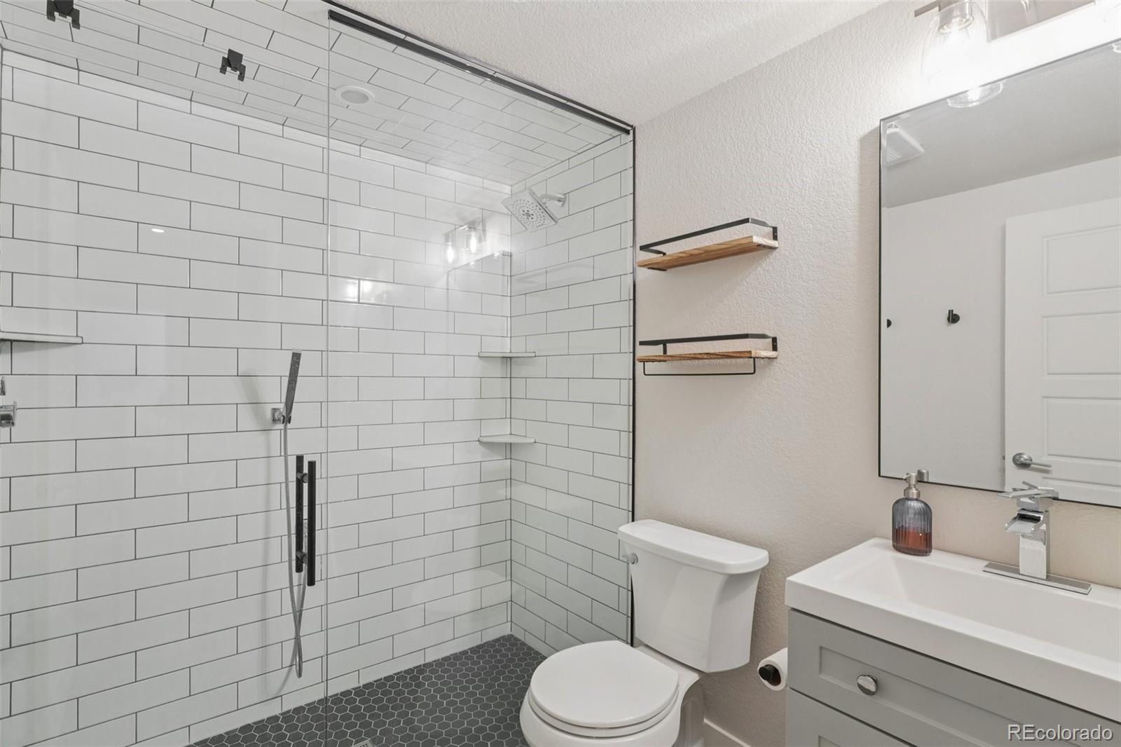 2005 West 66th Avenue Denver, CO 80221 - Photo 39 of 47 a bathroom with a toilet and shower