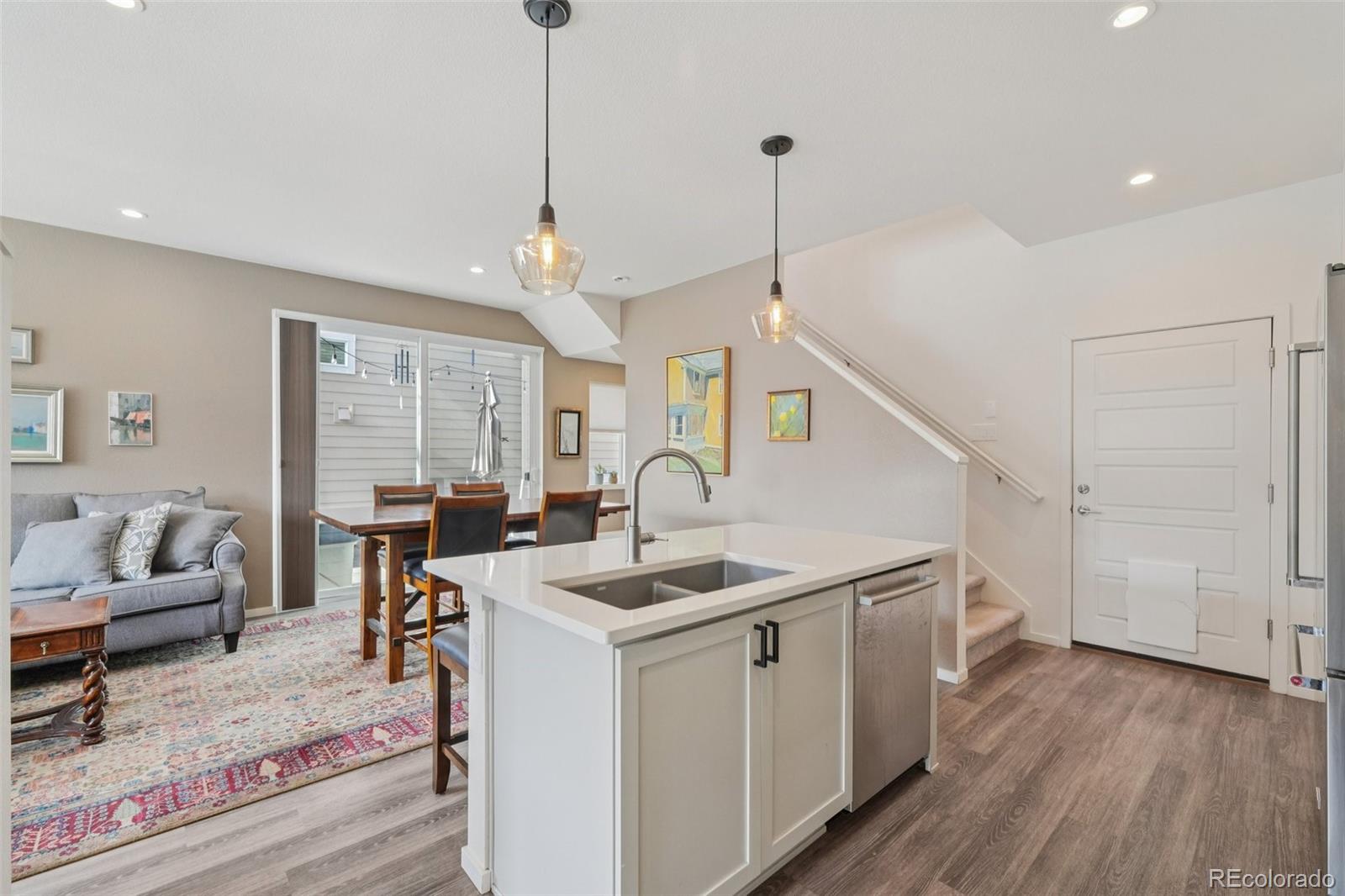 2005 West 66th Avenue Denver, CO 80221 - Photo 5 of 47 a view of a livingroom with furniture hardwood floor and a ceiling fan