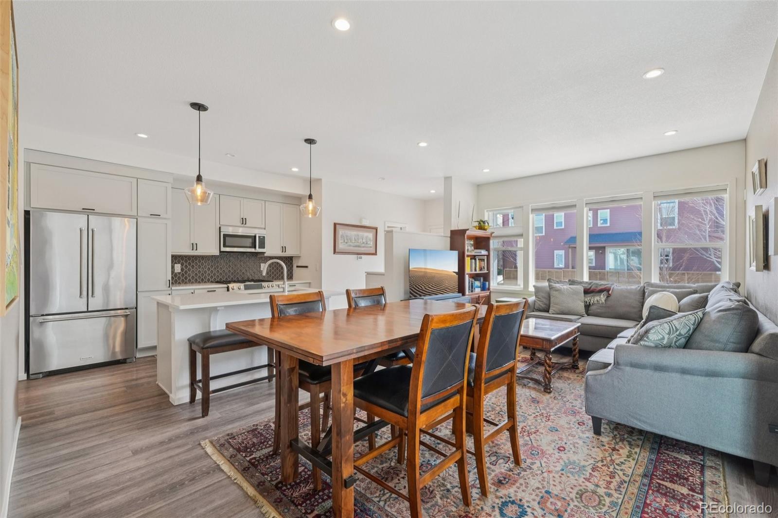 2005 West 66th Avenue Denver, CO 80221 - Photo 7 of 47 a living room with stainless steel appliances kitchen island granite countertop furniture and a kitchen view
