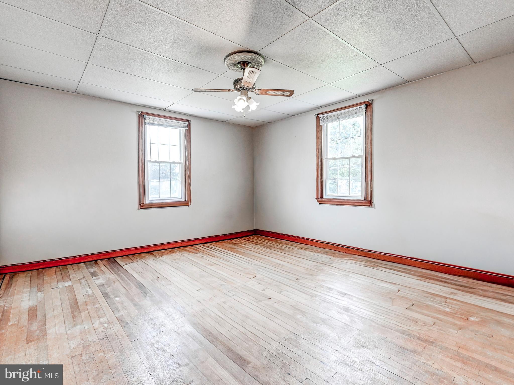 3206 Lynch Road Baltimore, MD 21219 - Photo 14 of 70 a view of an empty room with window and wooden floor