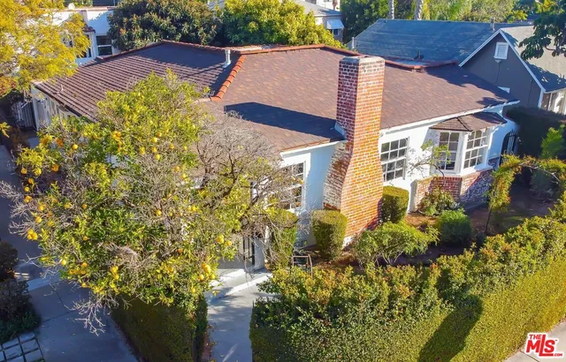 a view of a house with a yard and garden