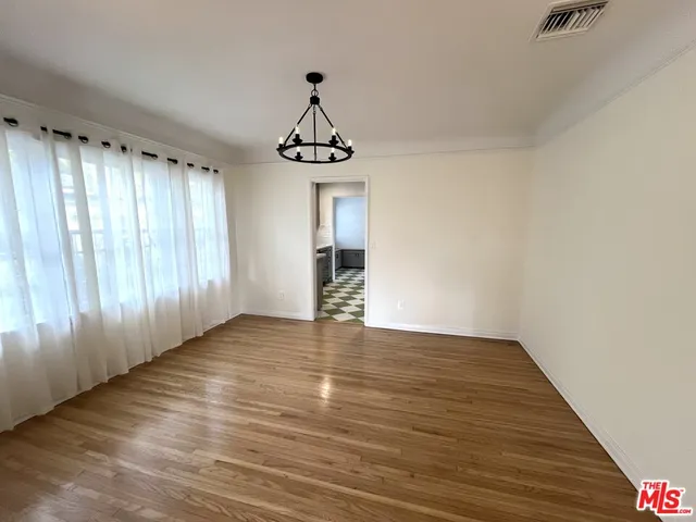 a kitchen with a checkered floor and a refrigerator