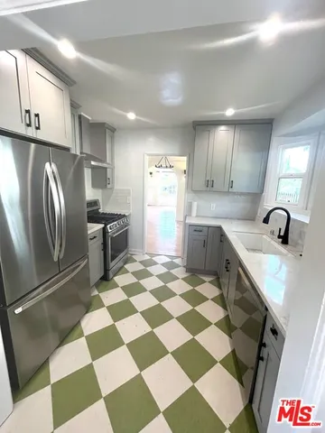 a kitchen with a checkered floor and a stove top oven