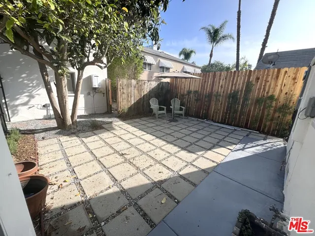 a view of a yard with plants and trees