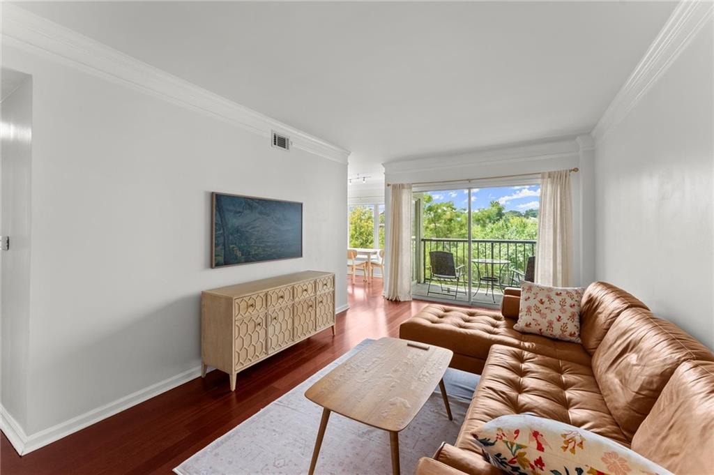 a living room with furniture a window and a flat screen tv